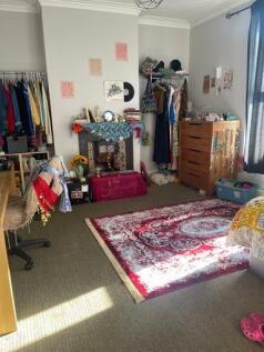 A cozy bedroom with personalized decor, a color...