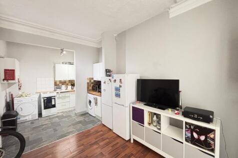 A bright and spacious living room featuring a m...