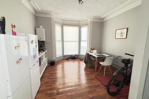 A bright and airy living room with large window...