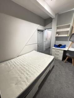 A bright and comfortable master bedroom featuri...