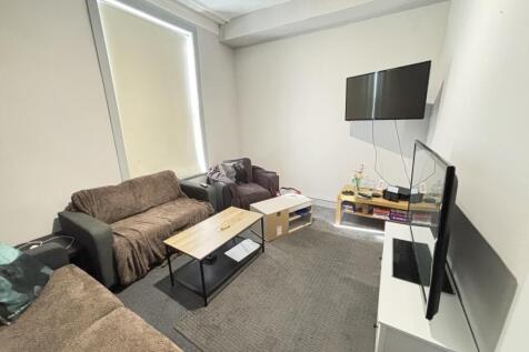 A spacious, well-lit modern living room featuri...