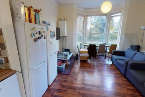 A bright and welcoming living room featuring la...