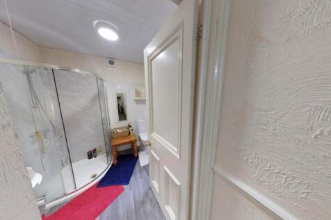 A modern, well-maintained bathroom with a large...