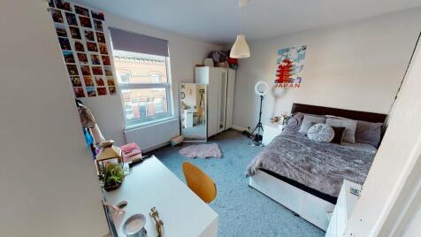 A bright and cozy double bedroom featuring a la...