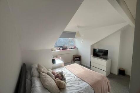 A bright and spacious master bedroom featuring ...