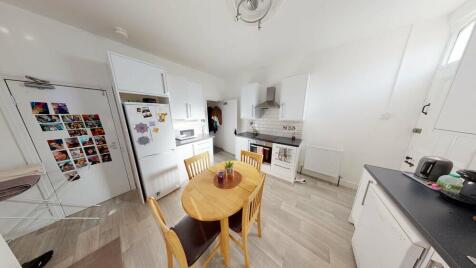 A spacious and well-lit contemporary living roo...