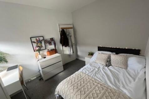 A well-maintained bedroom featuring a double be...