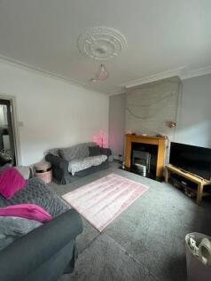 A cozy living room featuring comfortable sofas,...