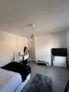 A spacious and well-lit living room with a mode...