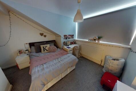 A cozy bedroom with a single bed, decorated wit...