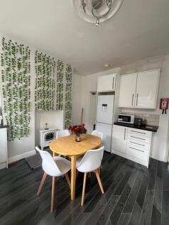 A bright and tidy kitchen area featuring a smal...