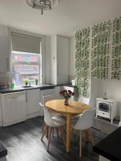 A bright and clean kitchen area featuring a rou...