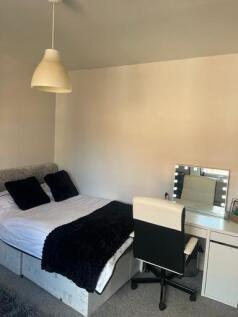 A cozy bedroom featuring a comfortable double b...