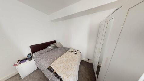 A comfortable double bedroom featuring a bed wi...