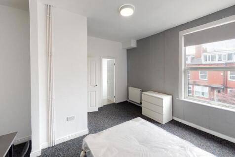 Bright and modern living room featuring large w...