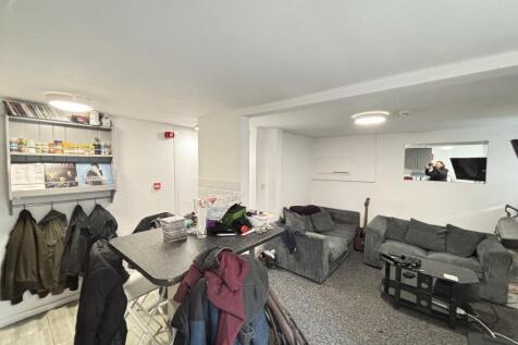 A spacious and modern living room featuring com...