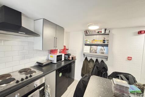 A modern, well-maintained kitchen with ample wo...