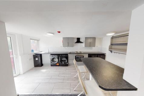 A modern, well-lit kitchen with ample counter s...