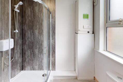 A clean and modern bathroom with a spacious sho...