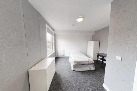 A bright and tidy bedroom with a large window p...