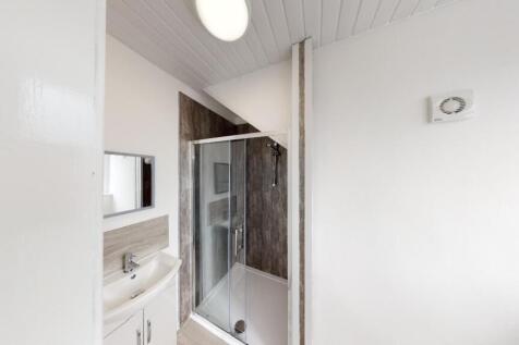 A modern bathroom featuring a shower enclosure,...