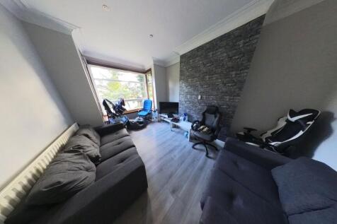 A spacious and well-lit living room featuring m...