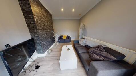 A modern, well-lit living room featuring a comf...