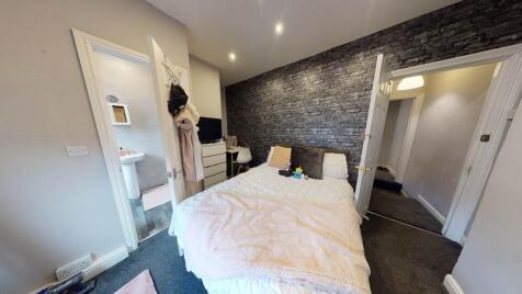 A well-maintained bedroom with a comfortable do...