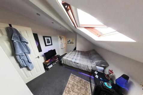 A cozy, well-maintained bedroom with natural li...