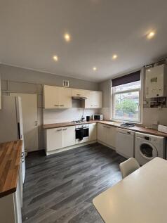 Bright and modern kitchen with ample cabinet sp...