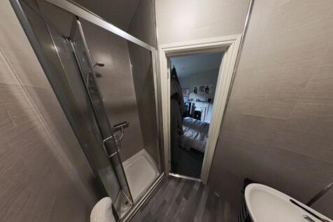 A clean and tidy bathroom with a shower cubicle...