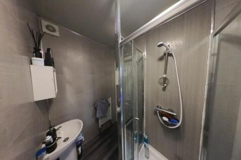 A clean and modern bathroom with a shower enclo...