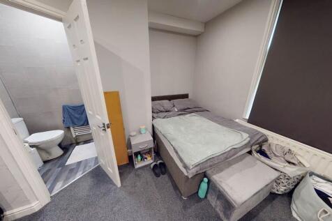 A compact bathroom with a toilet and minimal sp...