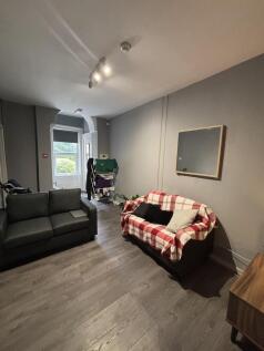 A bright and inviting living room featuring com...