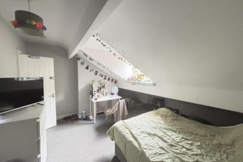 A well-maintained bedroom featuring a double be...