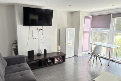 A bright and modern living room featuring a lar...