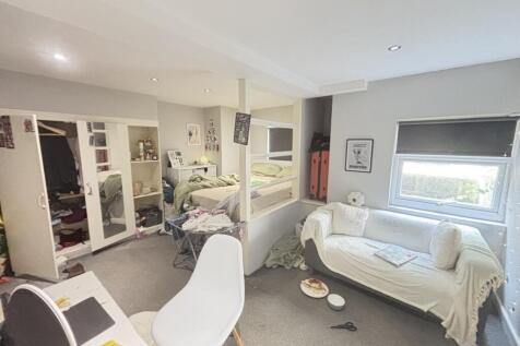 A bright and inviting living room featuring com...