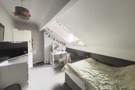 A well-maintained bedroom with a comfortable be...