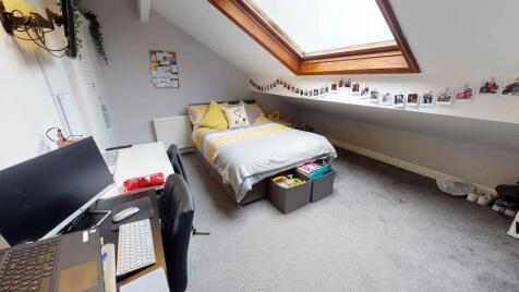 A well-lit, spacious double bedroom with ample ...