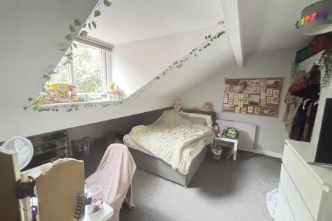 A bright and well-maintained bedroom featuring ...