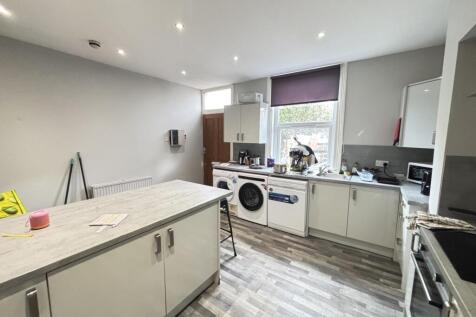 A modern, well-lit kitchen with ample workspace...