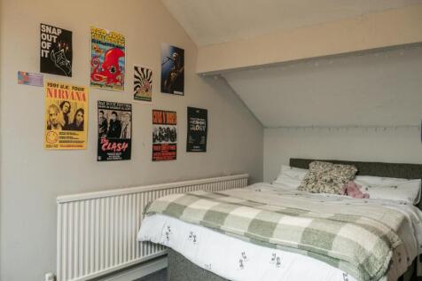 A cozy, well-organized bedroom featuring a doub...