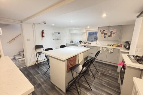 A modern, well-lit living room with ample space...