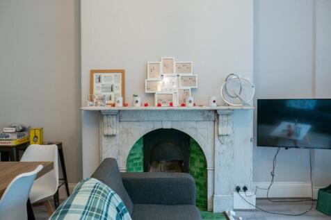 Modern living room featuring a fireplace with d...