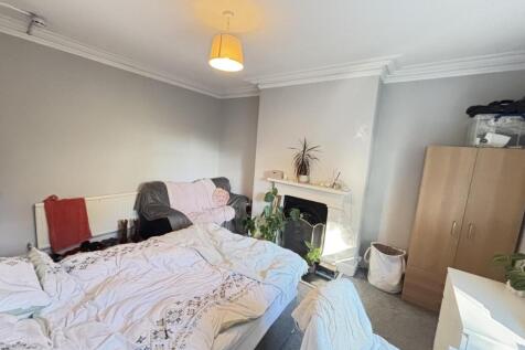 A well-lit and inviting living room featuring a...