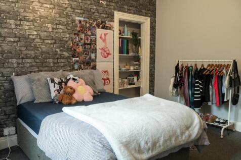 A cozy and well-maintained bedroom featuring a ...