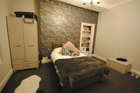 A spacious and inviting master bedroom featurin...