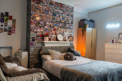 A cozy and well-maintained bedroom featuring a ...