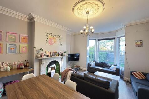 Bright and welcoming living room with ample nat...