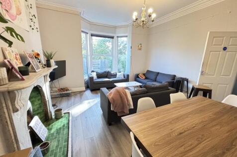 A bright and spacious living room with large wi...